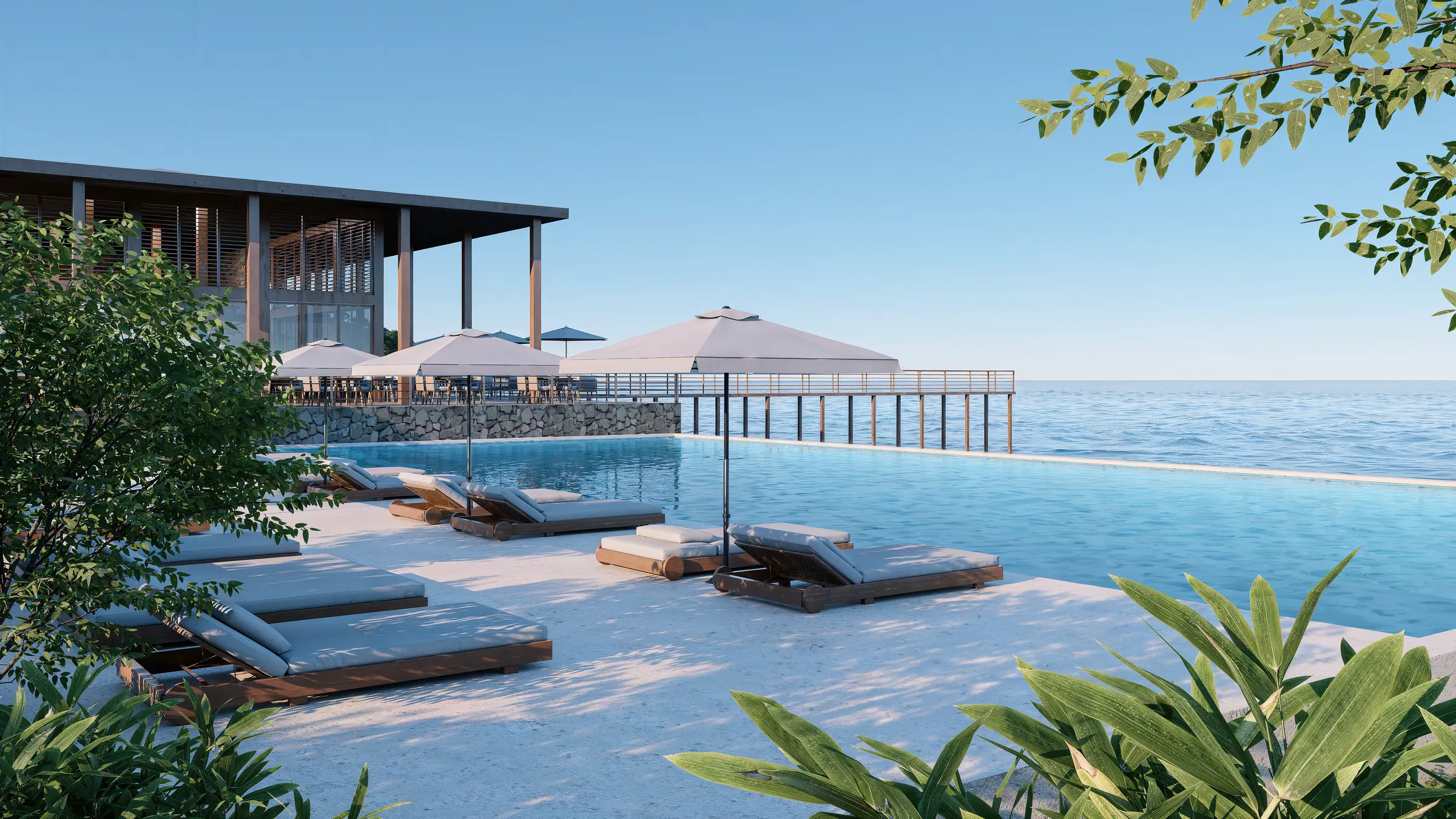 Coastal resort infinity pool with parasols and a pavilion over the sea