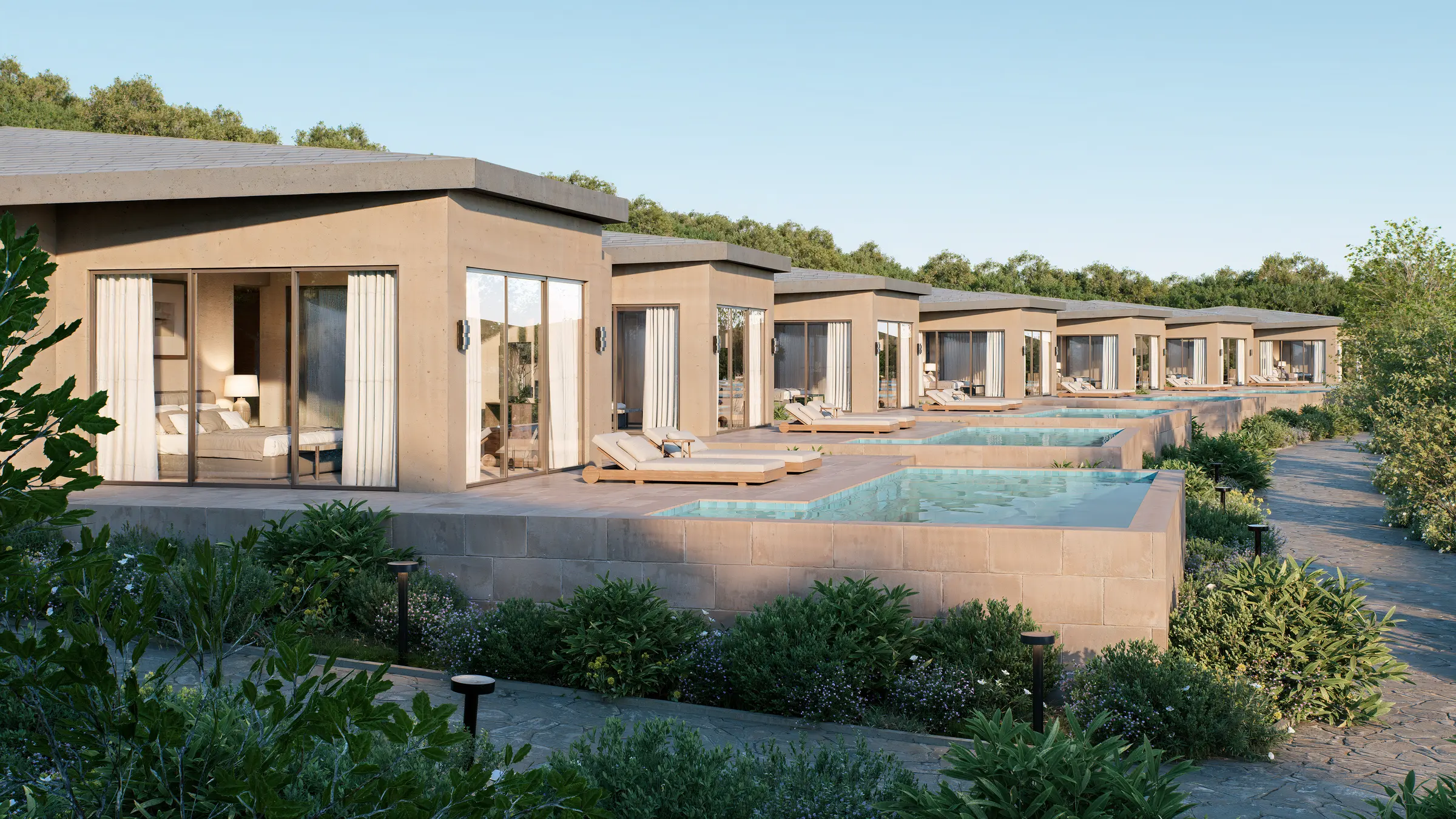 Row of resort villas with private plunge pools stepping down a hillside