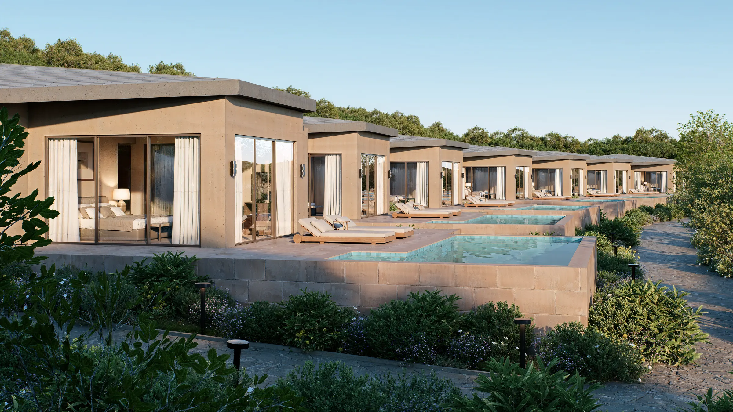 Row of resort villas with private plunge pools stepping down a hillside