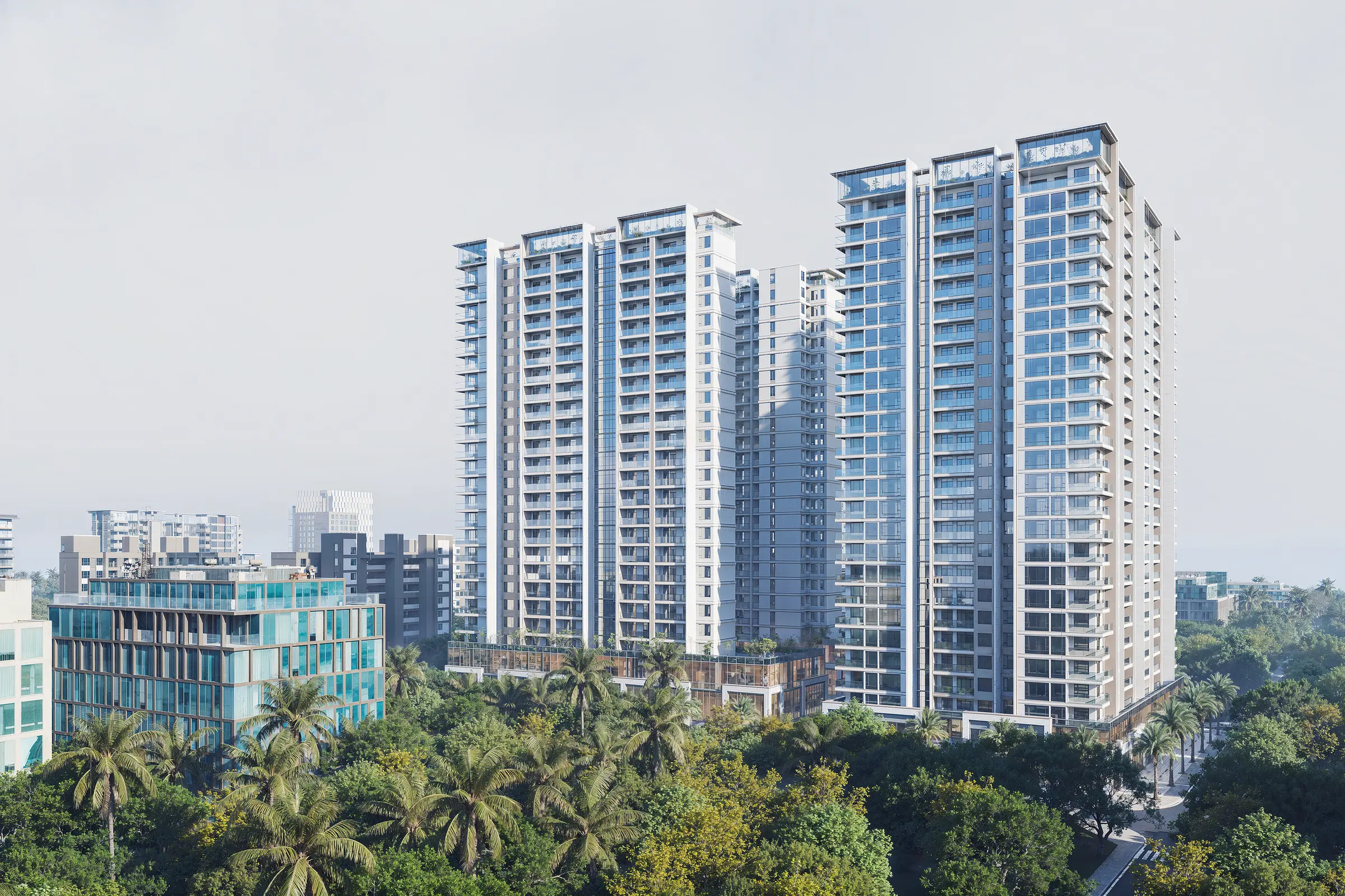 Twin high-rise residential towers rising above a green neighbourhood